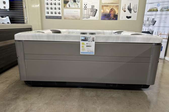 A bullfrog A6 spa from a front facing angle in the costal grey color.