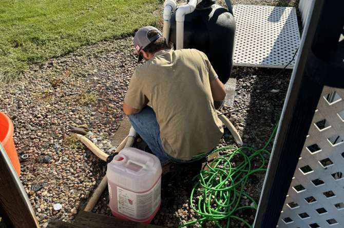 Brad in the middle of closing up a pool.