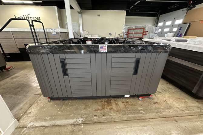 An Elite Series spa being displayed indoors.