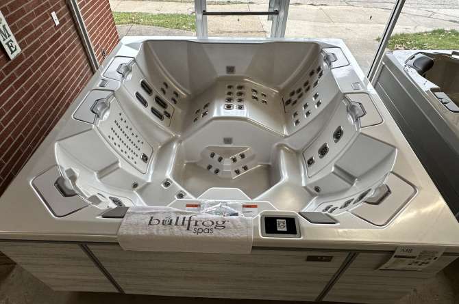 Bullfrog M8 spa being showcased in an indoor showroom.