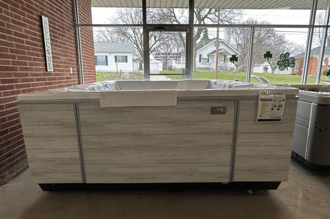 Bullfrog M8 spa being showcased in an indoor showroom with a front facing view.