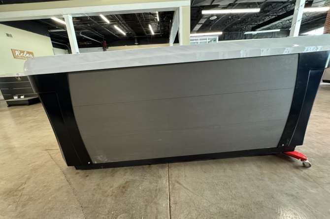 A Woodstock spa being displayed in a showroom.