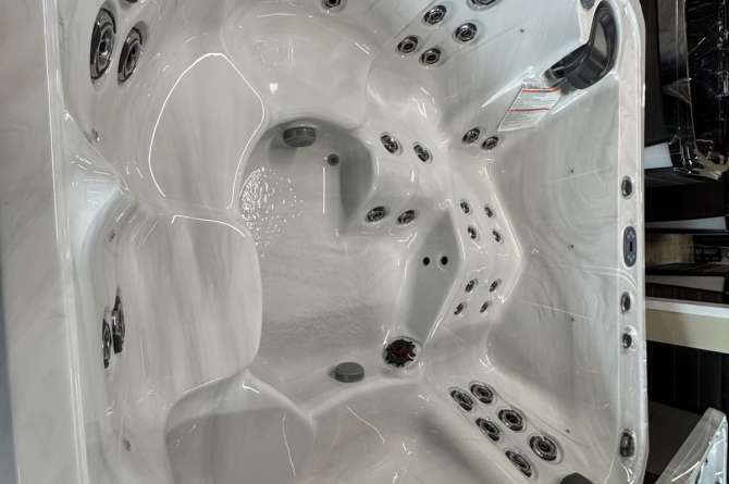 An interior view of a Woodstock Spa in a showroom.