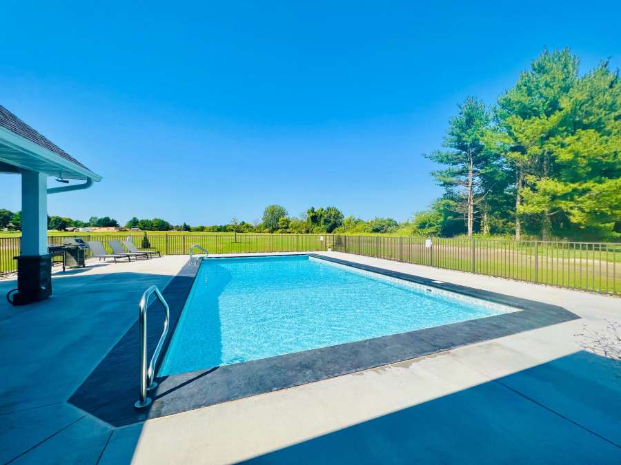 A photo of a in ground pool in a backyard.